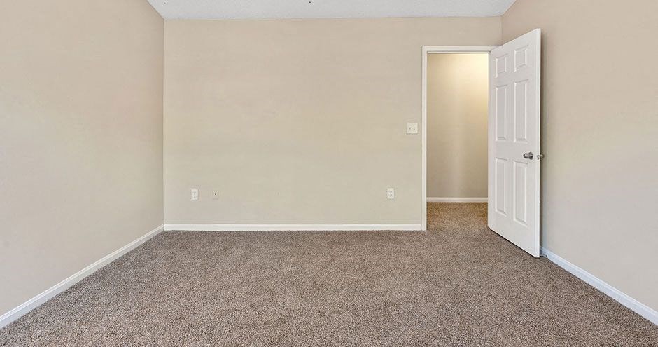 an empty room with a white door