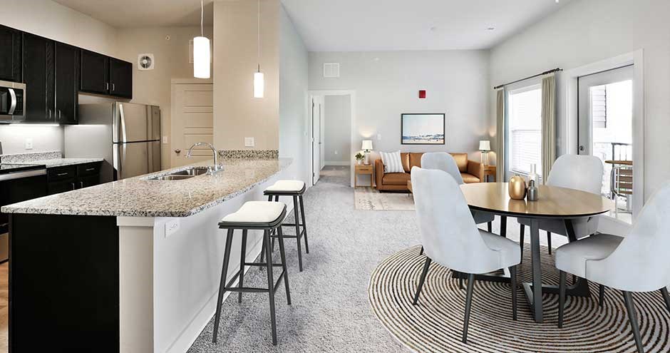 a kitchen and dining room with a table and chairs