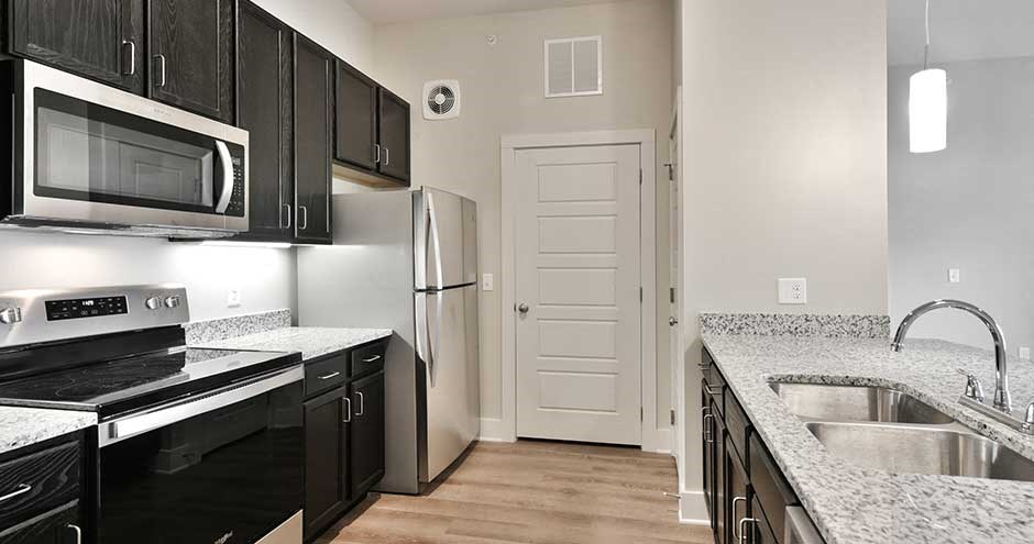 a kitchen with a sink and a refrigerator