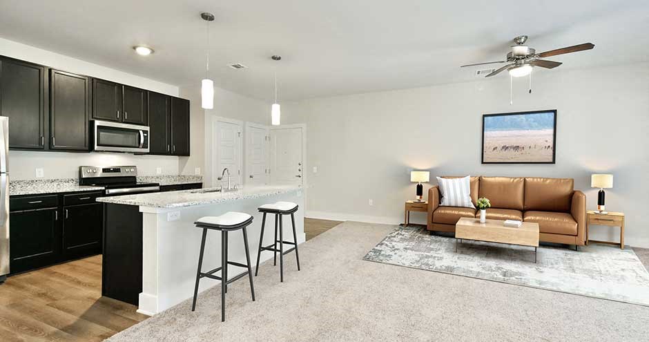 a living room with a kitchen and a couch