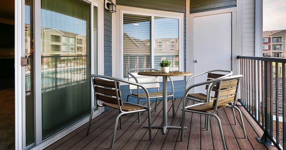 a patio with a table and chairs on a balcony