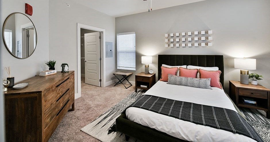 a bedroom with a bed and a mirror