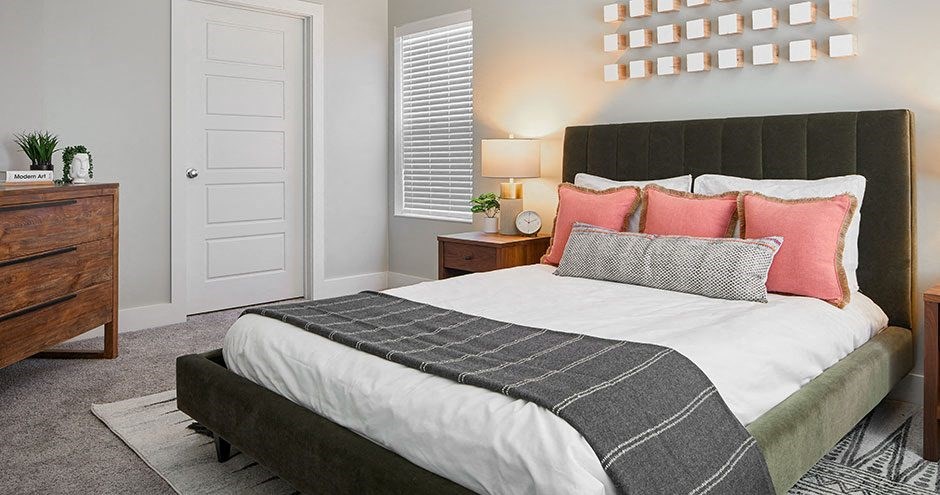 a bedroom with a bed and a dresser