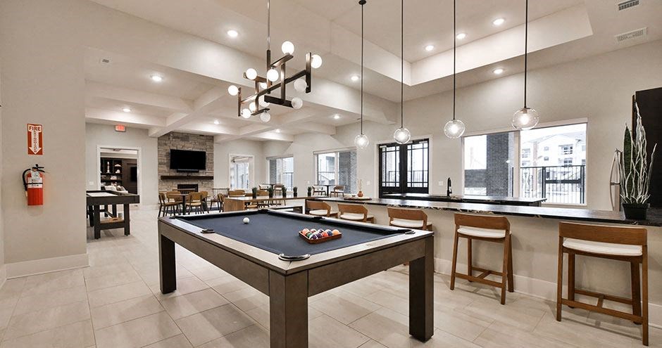 a game room with a pool table and a bar