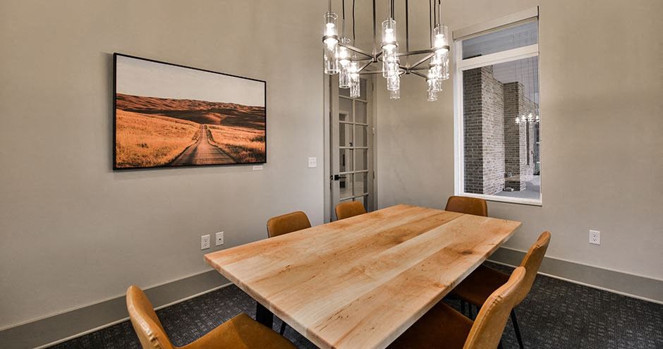 a dining room with a wooden table and chairs