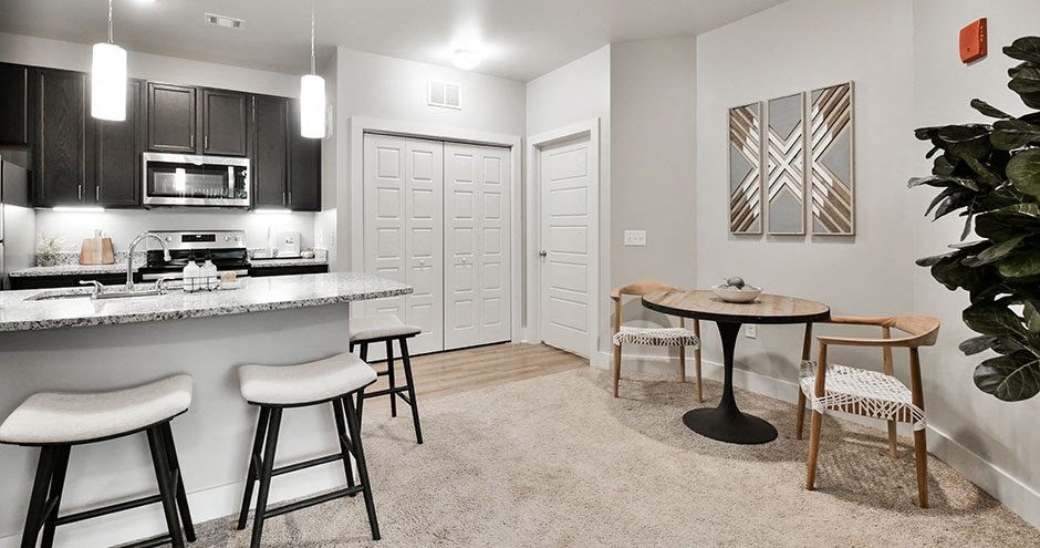 an open kitchen and living room with a table and chairs