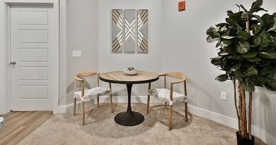 a dining room with a table and three chairs