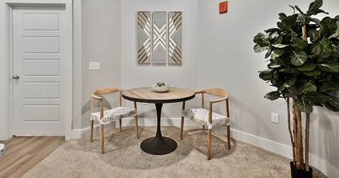 a dining room with a table and three chairs