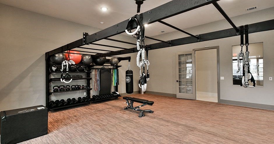 a gym with a lot of equipments hanging from the ceiling