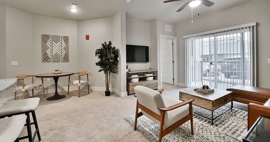 a living room with a couch and a table and a television