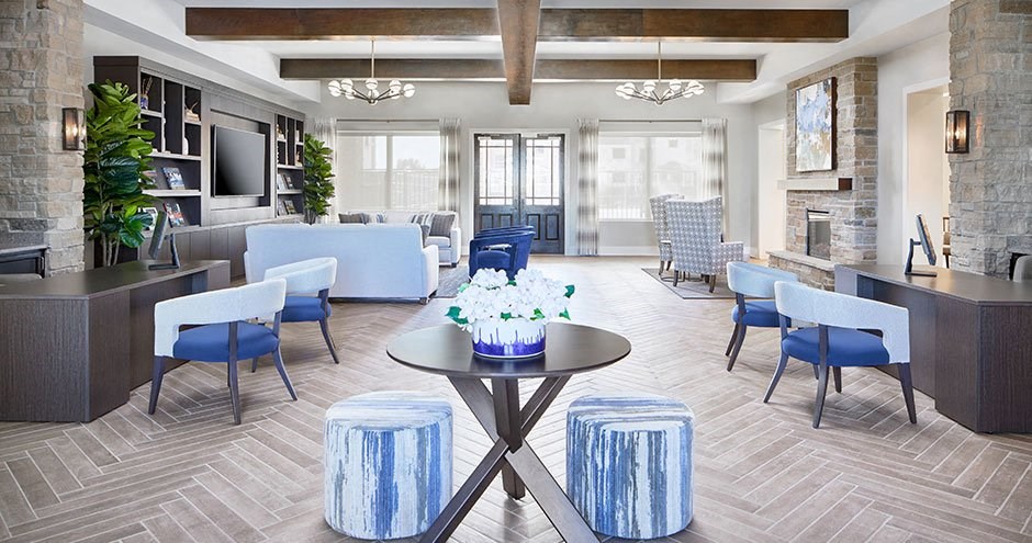 a living room with blue chairs and a table