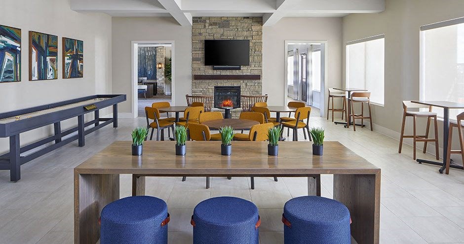 a living room with a fireplace and a table with chairs
