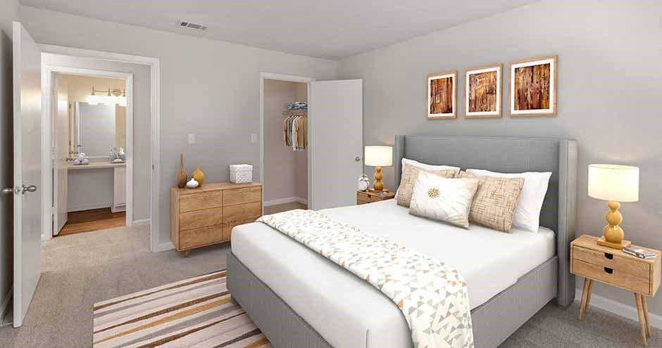 a bedroom with a large bed and a bathroom