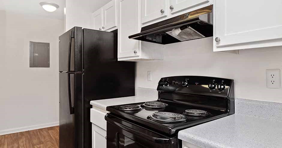 a kitchen with a black stove and a black refrigerator
