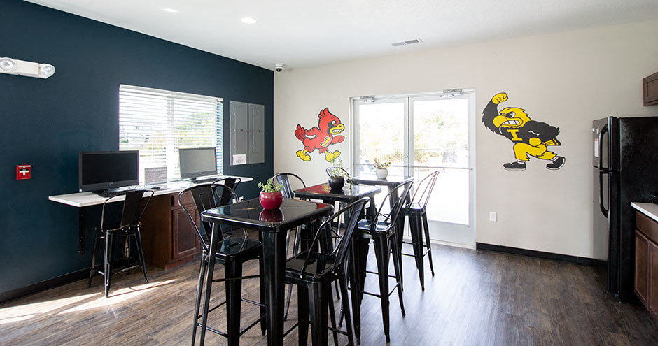 a dining room with a table and chairs      and a kitchen