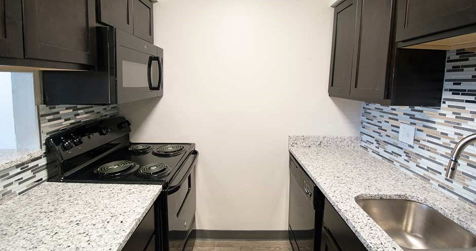 a kitchen with a stove and a sink