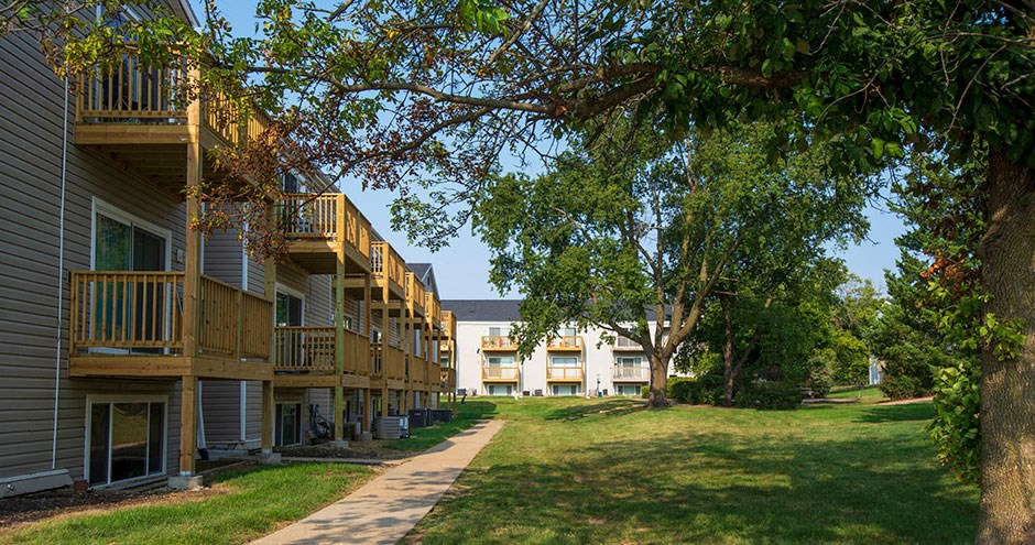 a row of apartments with balconies and trees