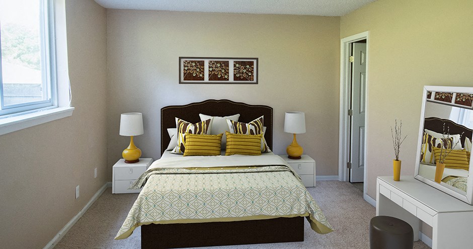 a bedroom with a bed and two night stands and a window