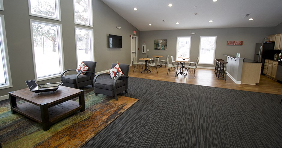 a living room with couches and chairs and a table