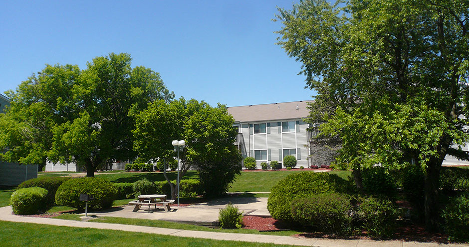 a park with a picnic table in front of a building
