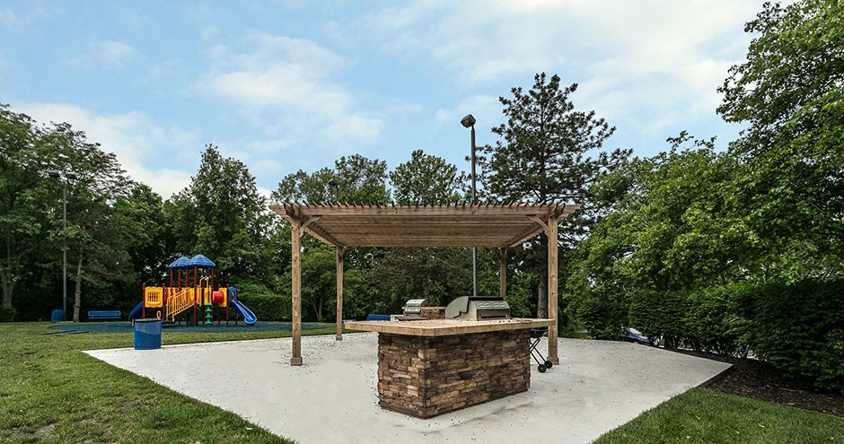 a pavilion with a fire pit and a playground