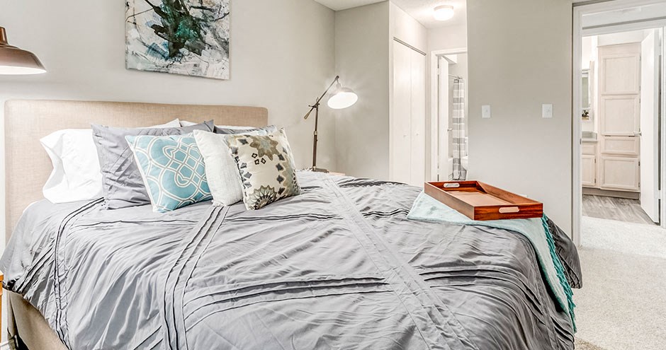 a bedroom with a bed and a lamp