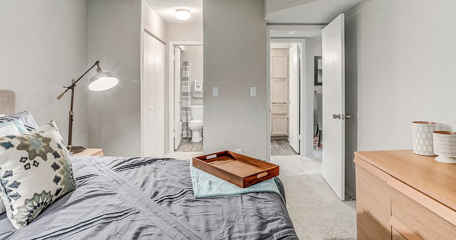 a bedroom with a bed and a view of a bathroom