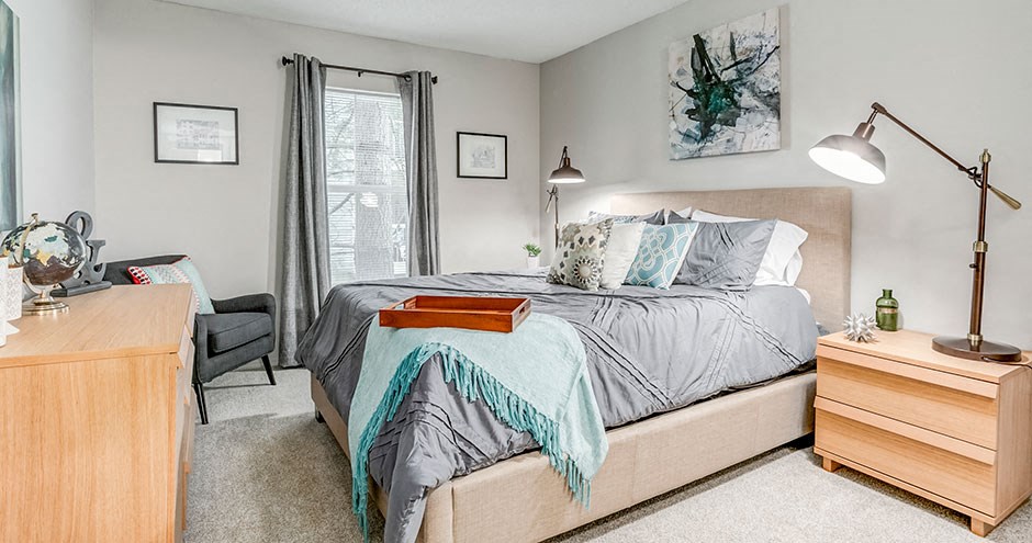 a bedroom with a bed and a desk