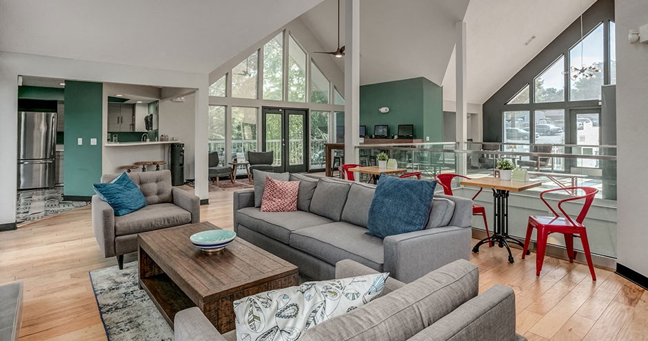 a living room with couches and a table with chairs