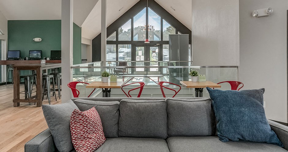 a living room with a couch and a table with chairs