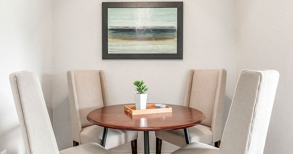 a dining room with a table and four chairs