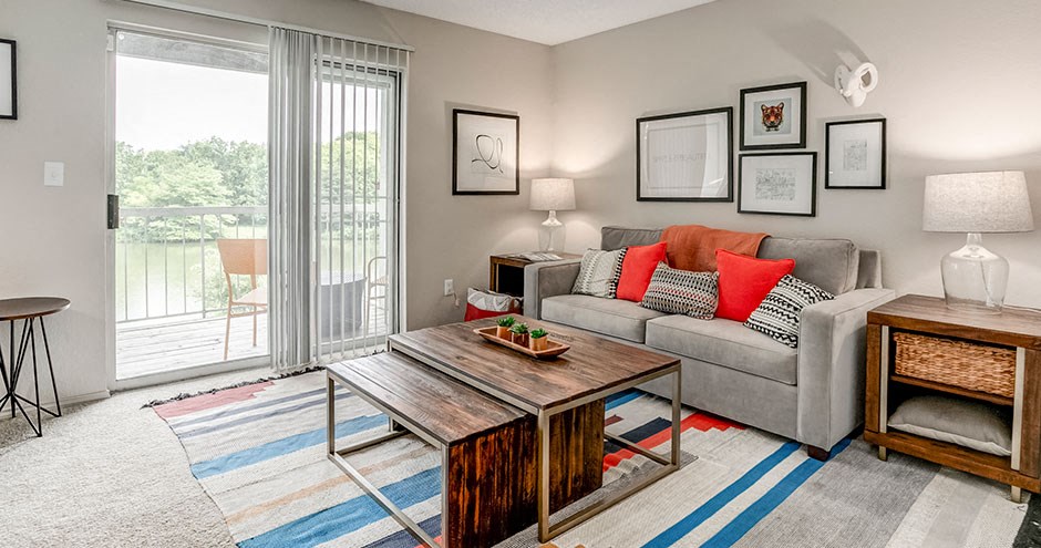 a living room with a couch and a coffee table and a sliding glass door