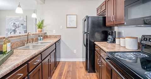 a kitchen with stainless steel appliances and granite counter tops
