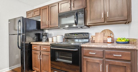 a kitchen with stainless steel appliances and wooden cabinets