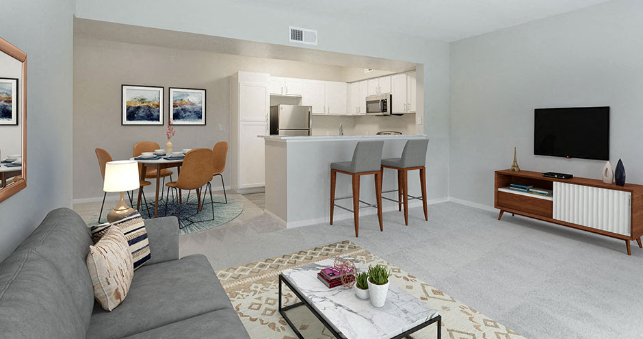 a living room and kitchen with a couch and a table