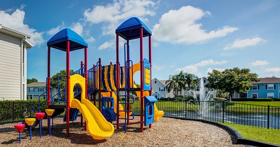 a playground with a water feature and slides