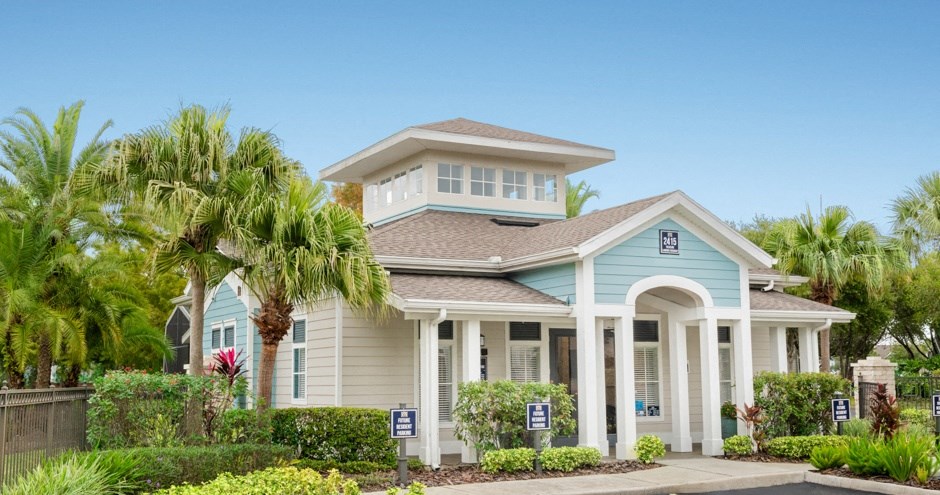 a house with palm trees in front of it