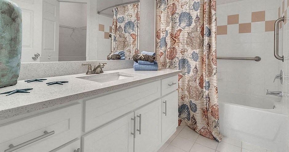 a bathroom with a sink and a tub and a shower curtain