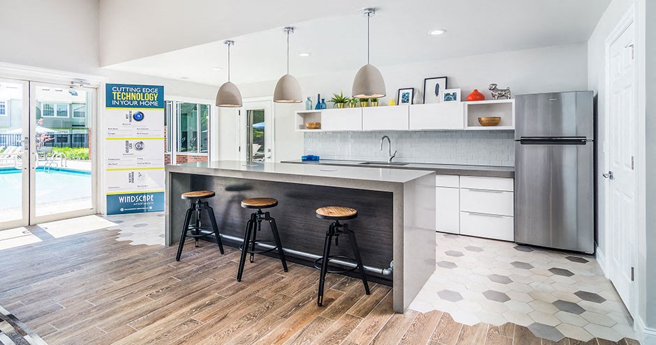 a kitchen with a counter and three bar stools