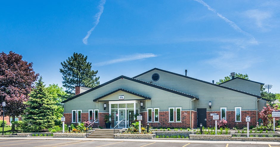 the front of our building with a blue sky