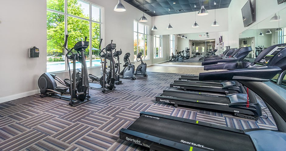 a gym full of cardio equipment and treadmills