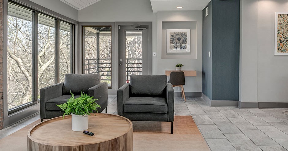 a living room with two chairs and a table