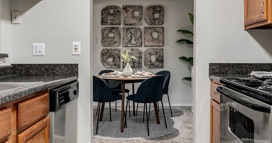 a kitchen and dining room with a table and chairs