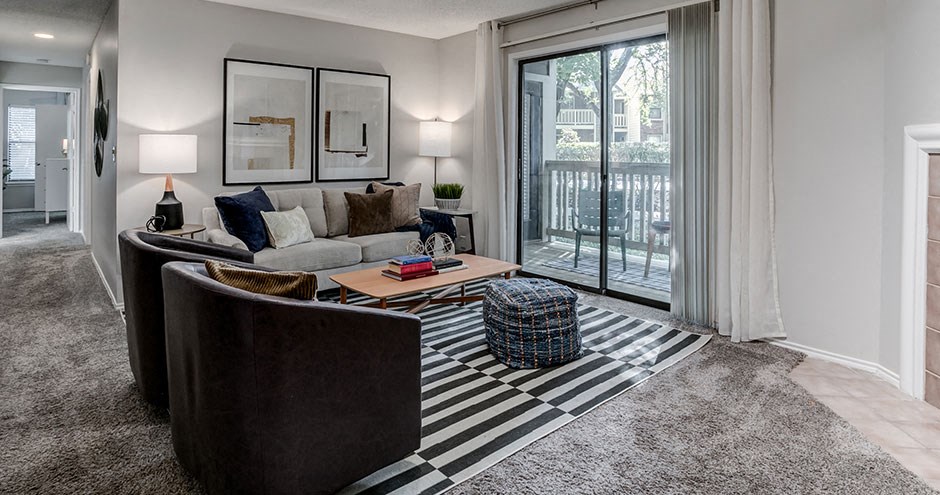 a living room with a couch and a sliding glass door