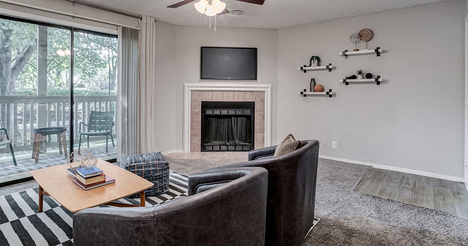 a living room with a fireplace and a tv