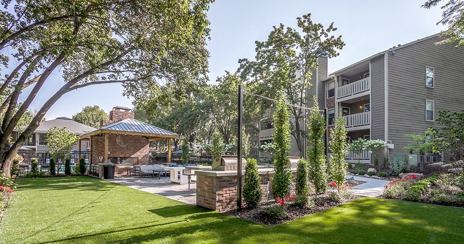 a backyard with a picnic area and a gazebo