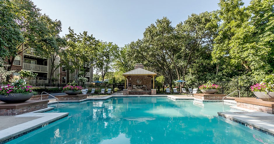 a swimming pool with a gazebo on the side of it