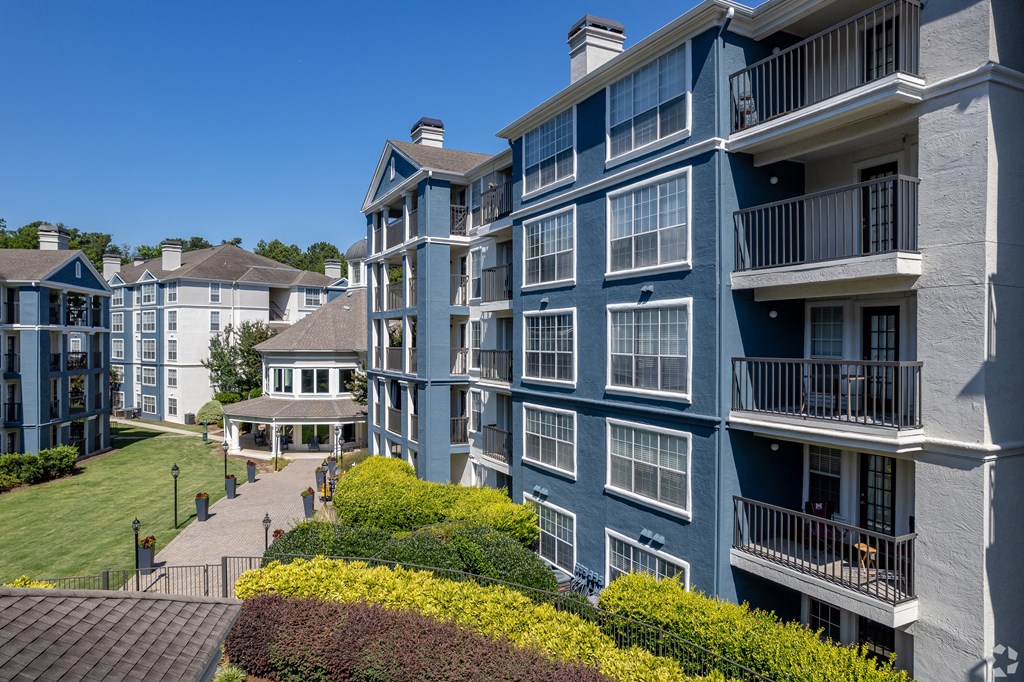 an exterior view of an apartment building on a sunny day