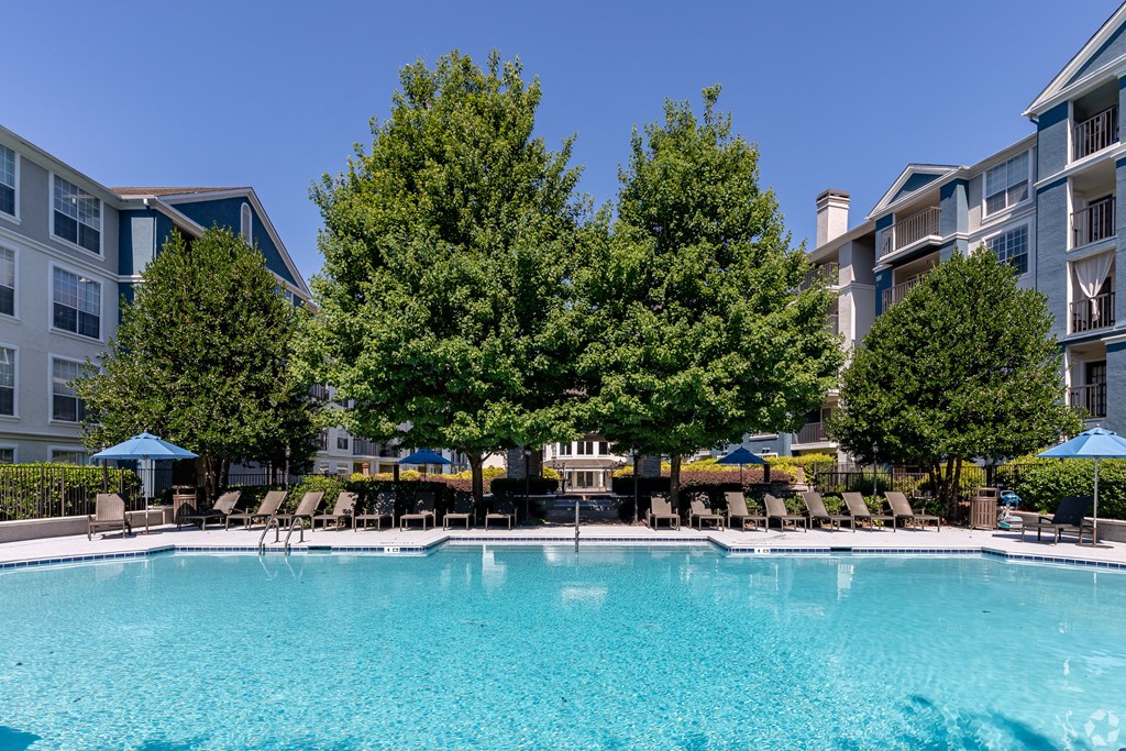 Atlanta, GA Apartments - Sparkling Pool With Lounge Chairs, Tables, And Maintained Landscaping.