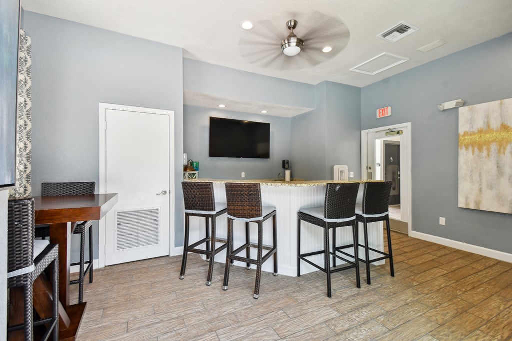 a living room with a bar and a television